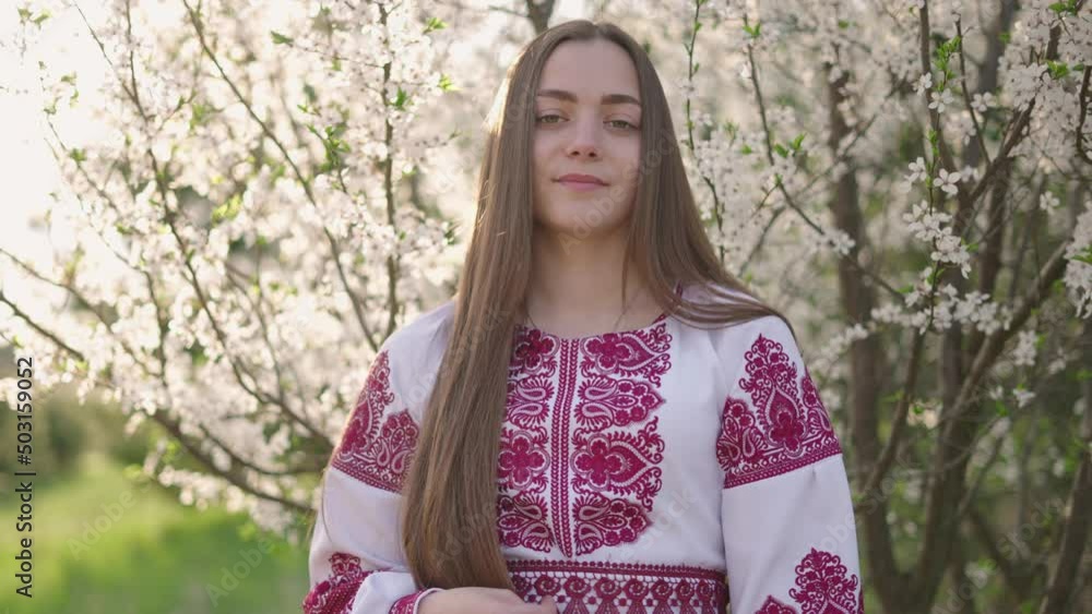 4k shot of young beautiful Ukrainian woman in vyshyvanka - ukrainian national clothes. Woman in countryside near the blossoming tree. Stand with Ukraine 4k shot of young beautiful Ukrainian woman in vyshyvanka - ukrainian national clothes. Woman in countryside near the blossoming tree. Stand with Ukraine