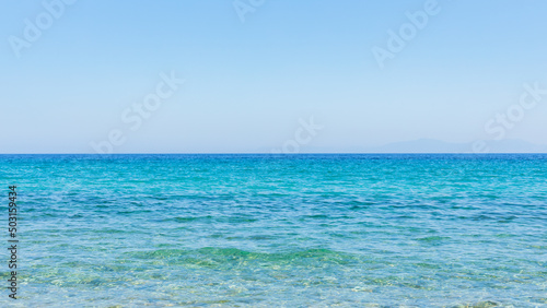 Turquoise sea and blue sky. Landscape with sea waves at a summer resort. Summer holiday concept