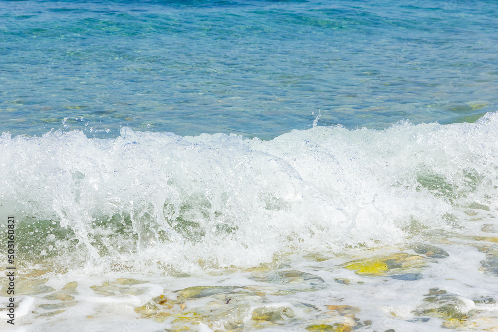Fototapeta premium Sea wave and pebble. Summer vacation concept. Sea wave with foam incident on the coastal shingle. Travel concept