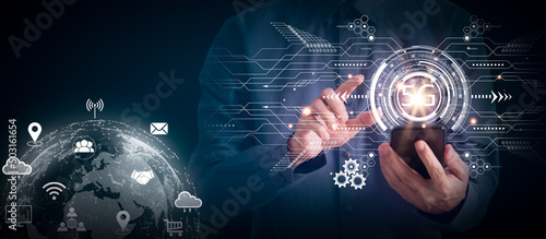 Businessman using 5G network technology connection with smartphone, system connection network wireless devices, 5G system digital hologram technology and internet of things concept