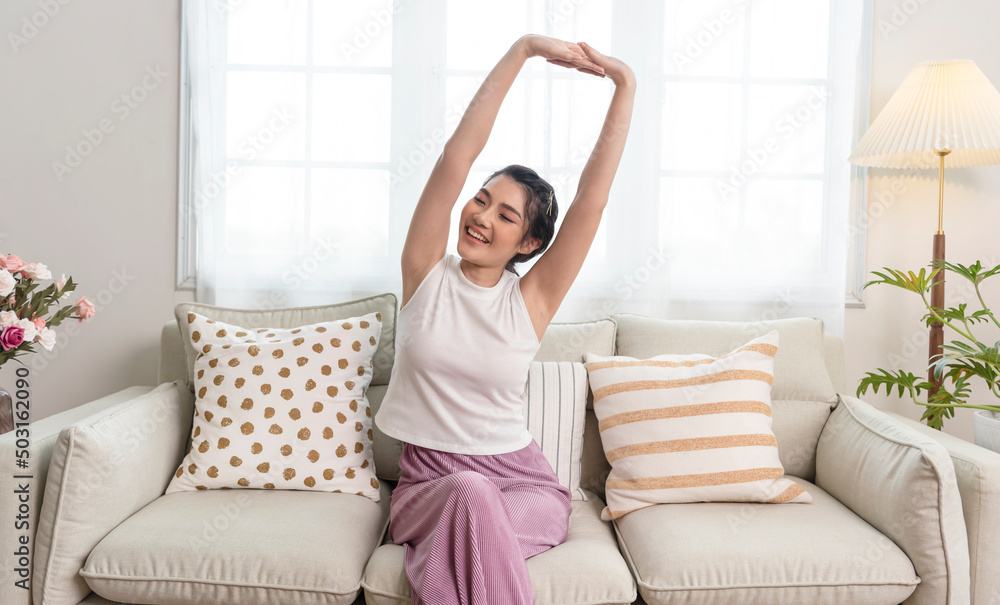 Home lifestyle asian woman relaxing on sofa in living room.