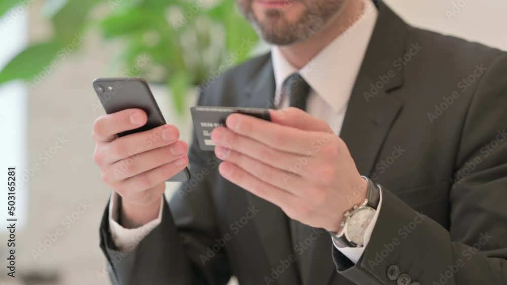 Close up of Middle Aged Businessman having Online Payment on Smartphone Close up of Middle Aged Businessman having Online Payment on Smartphone