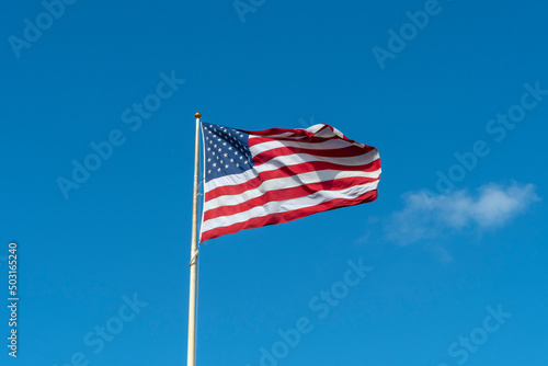 American flag in front of blue sky