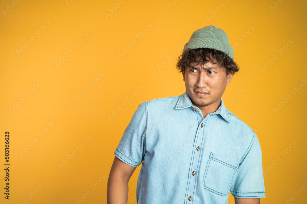 portrait of asian young man with disgusting expression isolated over white background
