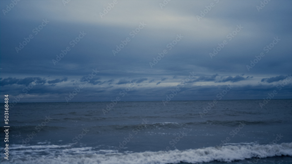 Dark sea landscape background on stormy weather. Blue nature scene on ocean view