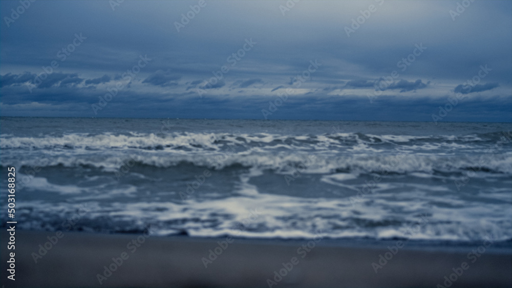 Ocean waves storming landscape beach. Dark sea tide water crashing nature coast.
