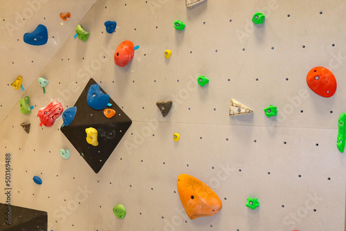 Colorful climbing holds on indoor bouldering wall