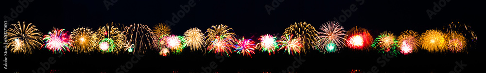 Long banner with bright colorful salute on a festive night. Explosions of colored salute in the black sky. Many multicolored salute flashes Long banner with bright colorful salute on a festive night. Explosions of colored salute in the black sky. Many multicolored salute flashes