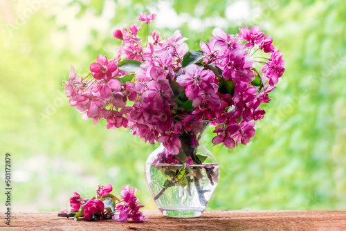 Beautiful bouquet of spring flowers.Pink apple tree flowers in a glass vase