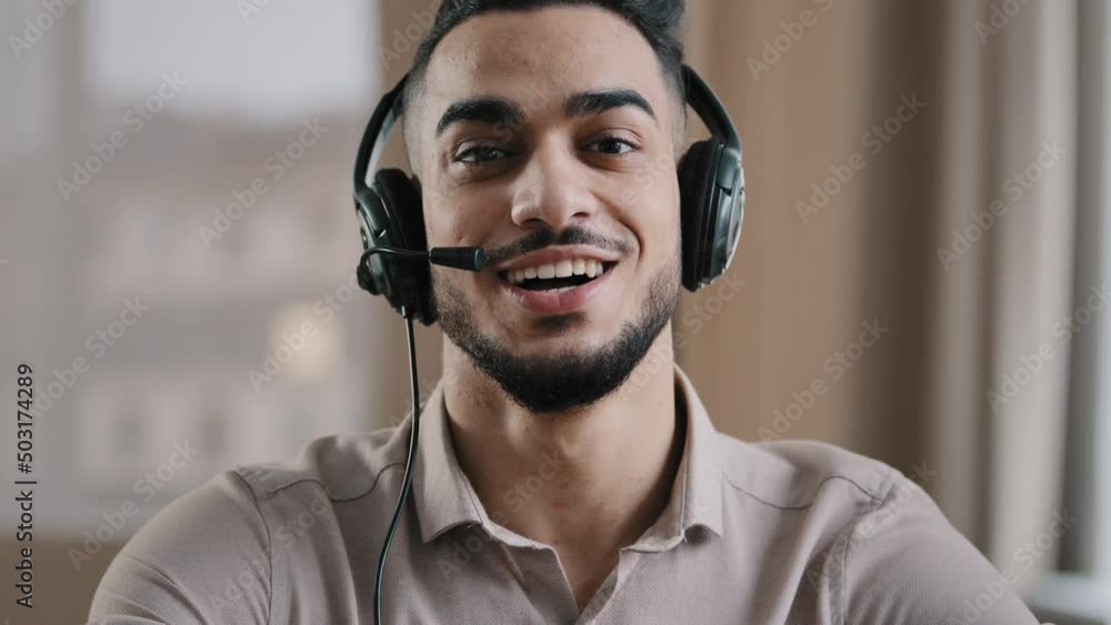 Smiling male operator hispanic businessman customer support service assistant representative greeting speak at web camera wear headset with microphone make video conference call remote job interview