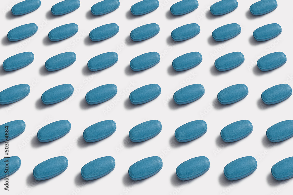 Ordered pattern of blue tablets on white background Ordered pattern of blue tablets on white background