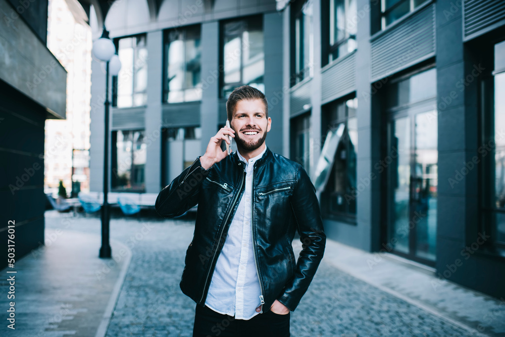 Fototapeta premium Male talking on cellphone on street
