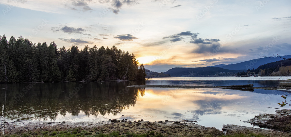 Fototapeta premium Panoramic View of a Canadian Landscape in Shoreline Trail, Port Moody, Greater Vancouver, British Columbia, Canada. Park in a Modern City during a colorful Sunset Sky. Nature Background Panorama