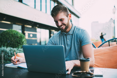 Male remote worker using computer on veranda