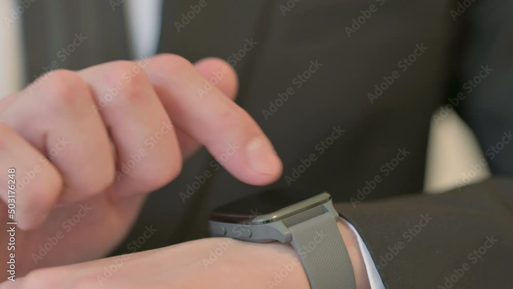 Close up of Hands of Middle Aged Businessman using Smart Watch Close up of Hands of Middle Aged Businessman using Smart Watch