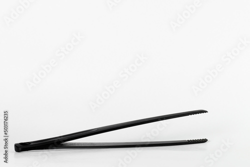 Black tweezer tongs for cooking and serving food