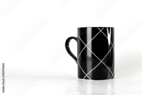 Black mug with stripes isolated on a white background with copy space 