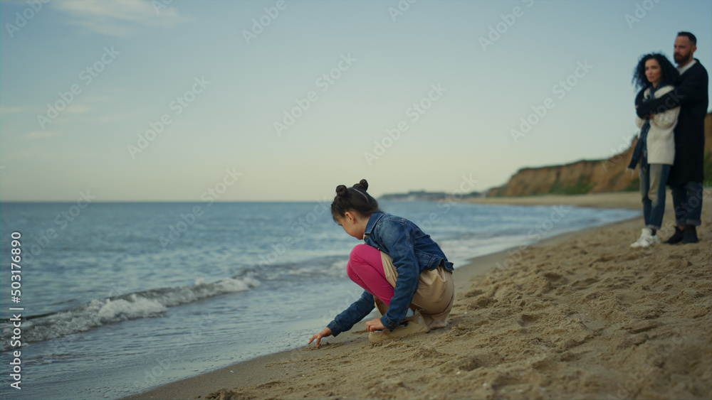 Young family relaxing vacation together at sea beach outdoors. Holiday concept. Young family relaxing vacation together at sea beach outdoors. Holiday concept.