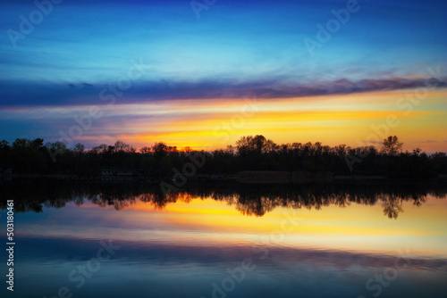 Beautuful blue and yellow sunset on the Dnipro River © tverkhovynets