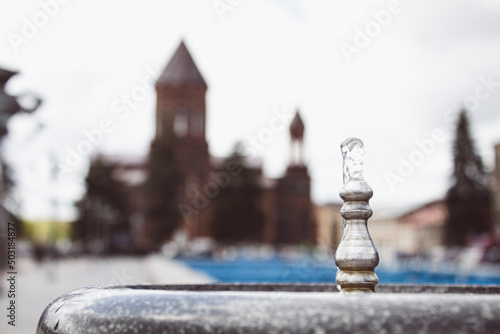 drinking fountain on the background of the church photo