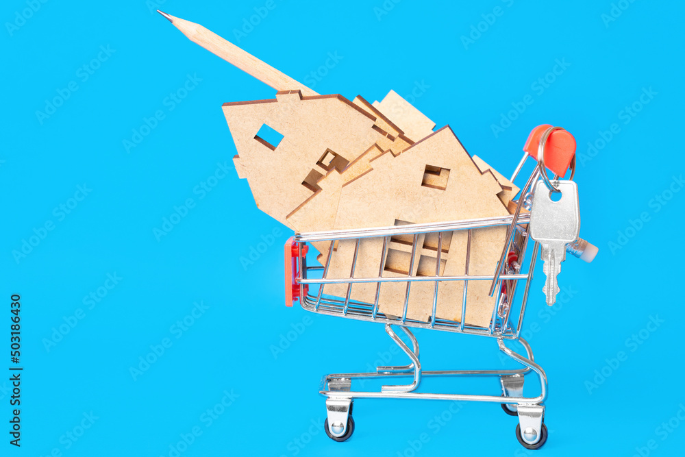 Toy house model parts in a shopping cart with keys
