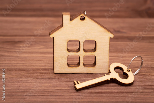 Wooden key with a flat wooden house model © Katie Chizhevskaya