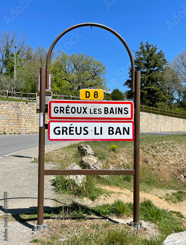 Gréoux-les-Bains, France - April 27, 2022: City entrance sign of Gréoux-les-Bains, a commune in the Alpes-de-Haute-Provence department in France.