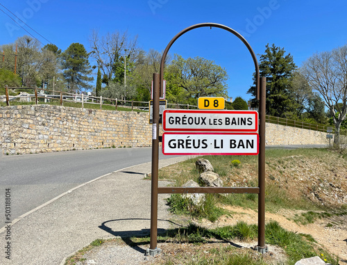 Gréoux-les-Bains, France - April 27, 2022: City entrance sign of Gréoux-les-Bains, a commune in the Alpes-de-Haute-Provence department in France.