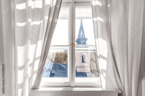 White wooden classic window with curtains and prague view