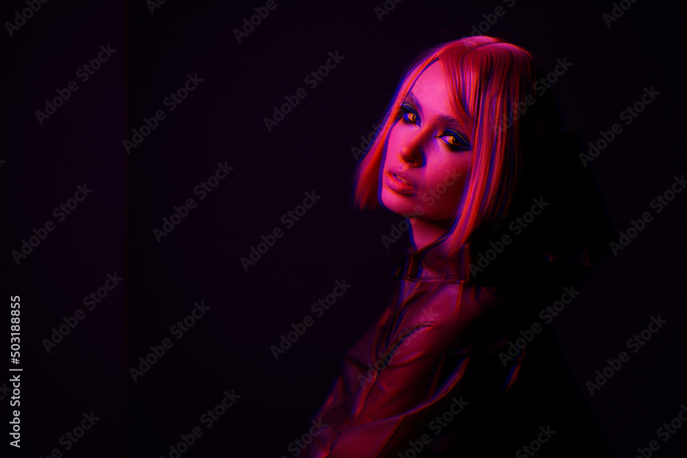 Woman in futuristic costume. Augmented reality game, future technology, AI concept. VR. Neon red light. Woman in futuristic costume. Augmented reality game, future technology, AI concept. VR. Neon red light.