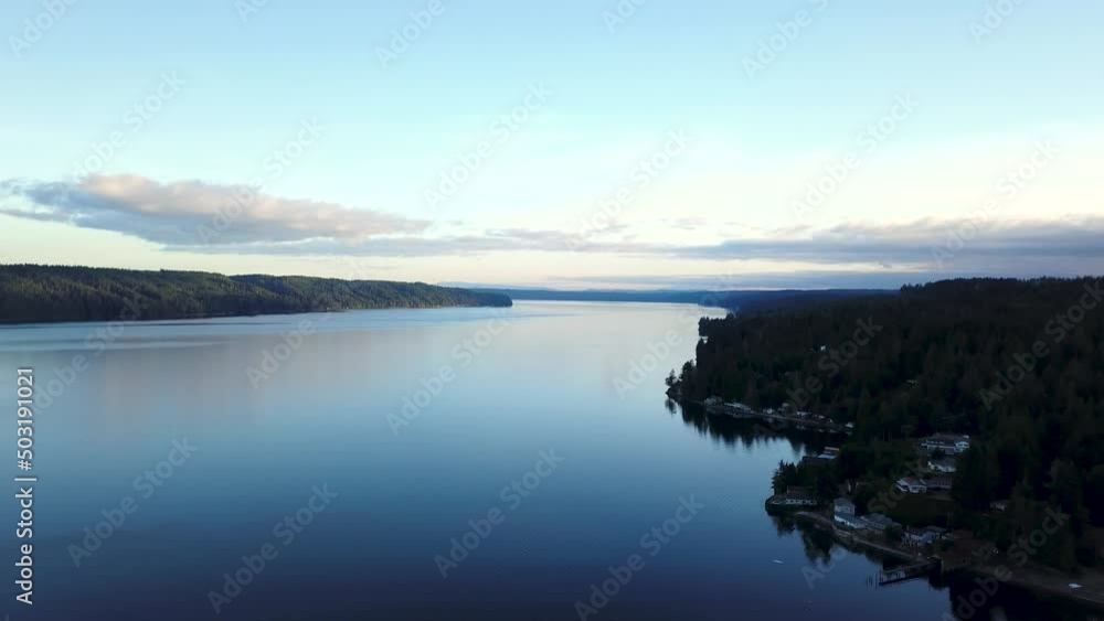 Aerial flying over nice houses next to the Hood Canal in Washington at sunset. Aerial flying over nice houses next to the Hood Canal in Washington at sunset.