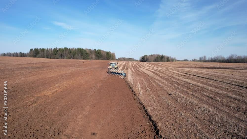 Tractor plowing field, drone view. Cultivated land and soil tillage. Tractor with disc cultivator on cultivating. Agricultural tractor on field cultivation. Tractor disk harrow on plowing field. Tractor plowing field, drone view. Cultivated land and soil tillage. Tractor with disc cultivator on cultivating. Agricultural tractor on field cultivation. Tractor disk harrow on plowing field.