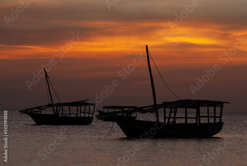 Zanzibar, Tanzania, Sunset on the Indian Ocean with boats.