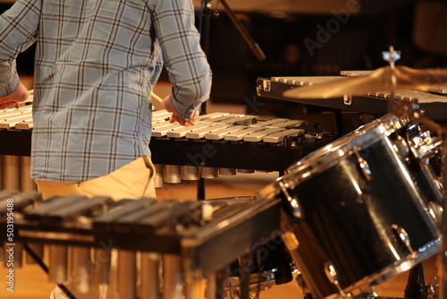 A person playing percussion close-up musical background image of drums selective focus on the keys photo