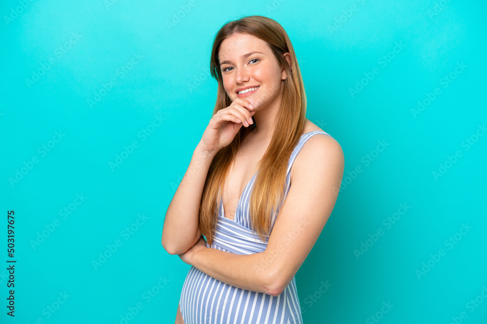Young woman isolated on blue background in swimsuit in summer holidays Young woman isolated on blue background in swimsuit in summer holidays