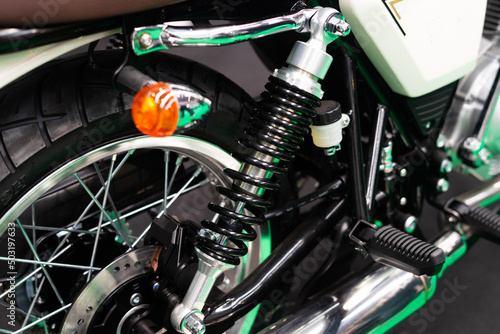 Detail of the suspension on the rear wheel of a custom motorbike