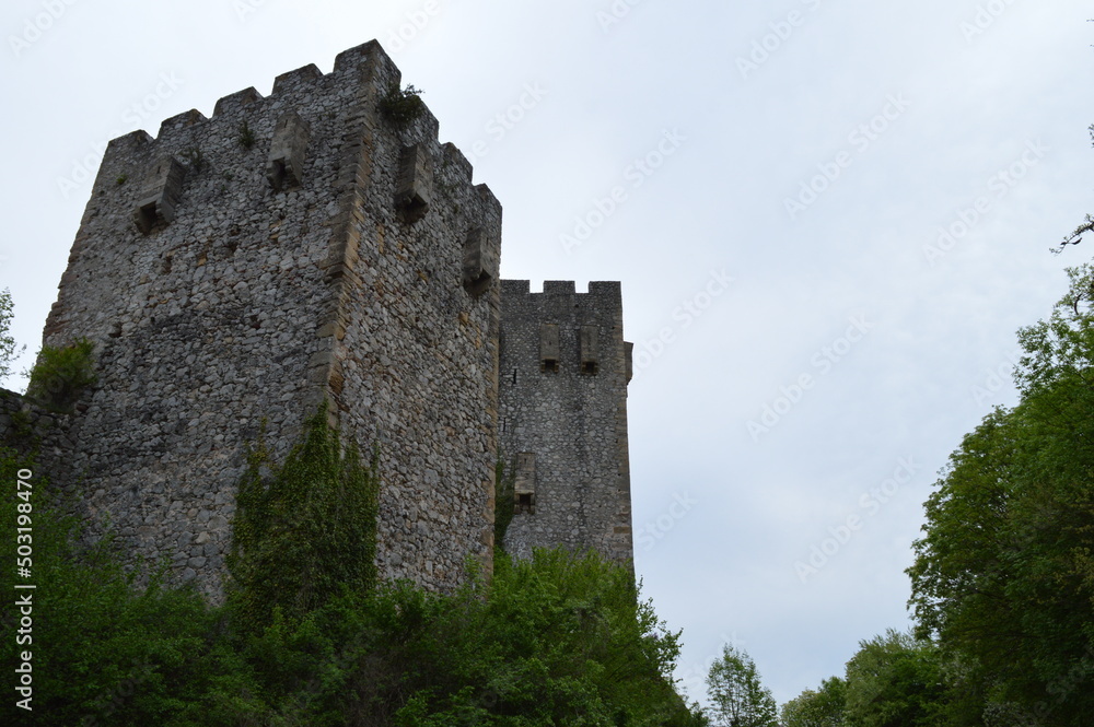Stone walls and towers of a medieval castle from the 15th century