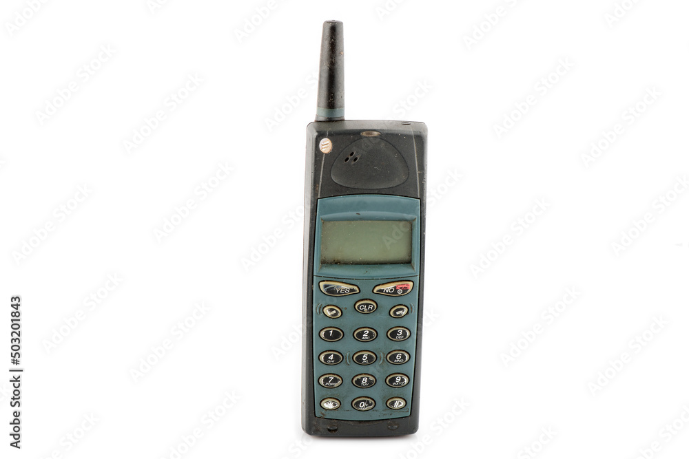 Old mobile phone in different colors. Retro technology of cellular devices located on a white background. Old technical display Old mobile phone in different colors. Retro technology of cellular devices located on a white background. Old technical display