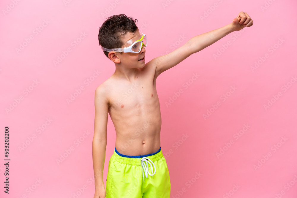 Little caucasian boy wearing a diving goggles isolated on pink background giving a thumbs up gesture Little caucasian boy wearing a diving goggles isolated on pink background giving a thumbs up gesture