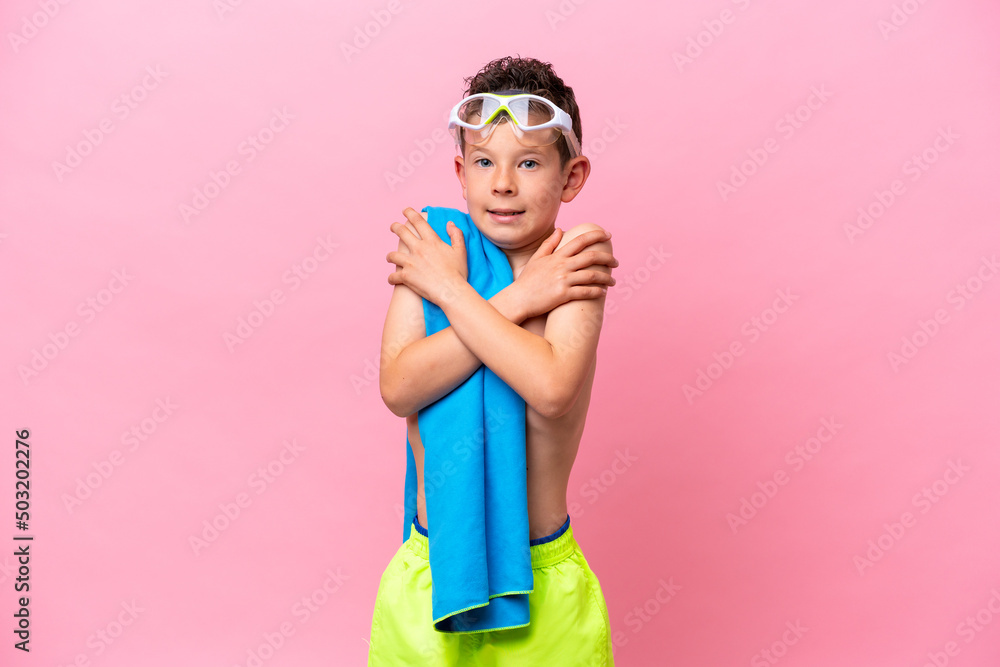 Little caucasian boy wearing a diving goggles isolated on pink background Little caucasian boy wearing a diving goggles isolated on pink background