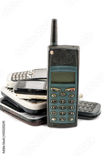 Old mobile phone in different colors. Retro technology of cellular devices located on a white background. Old technical display