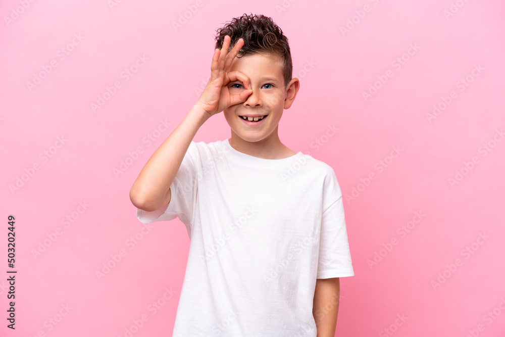 Little caucasian boy isolated on pink background showing ok sign with fingers Little caucasian boy isolated on pink background showing ok sign with fingers