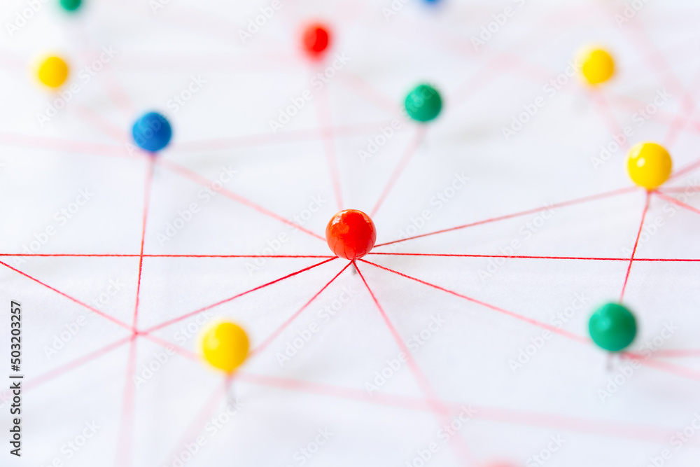 Linking entities, Blockchain, social media, Communications Network, The connection between the two networks. Network simulation on paper linked together by yarn Linking entities, Blockchain, social media, Communications Network, The connection between the two networks. Network simulation on paper linked together by yarn