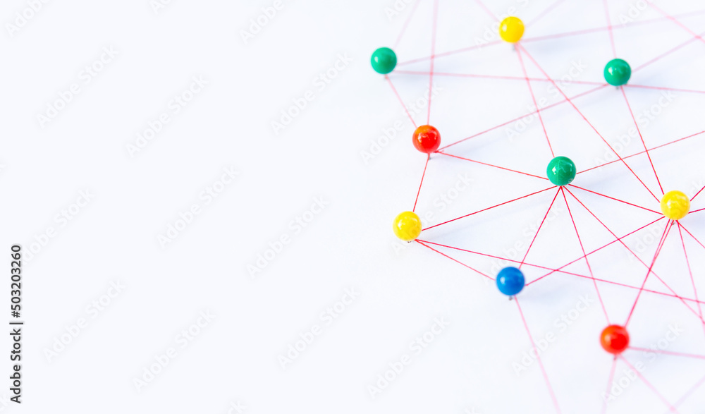 Linking entities, Blockchain, social media, Communications Network, The connection between the two networks. Network simulation on paper linked together by yarn Linking entities, Blockchain, social media, Communications Network, The connection between the two networks. Network simulation on paper linked together by yarn