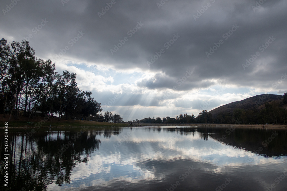 A Quiet Lake with Clouds Reflecting on the Surface