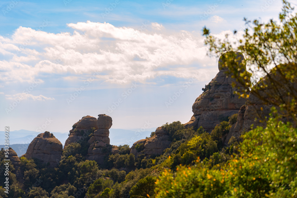 mountain scenery. rock mountains, green sunlit plants and blue sky. Mountain of Montserrat Spain. Mediterranean view.