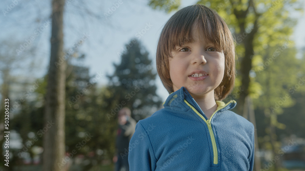 Little cute boy posing portrait looking at camera and smiling cheerfully Little cute boy posing portrait looking at camera and smiling cheerfully
