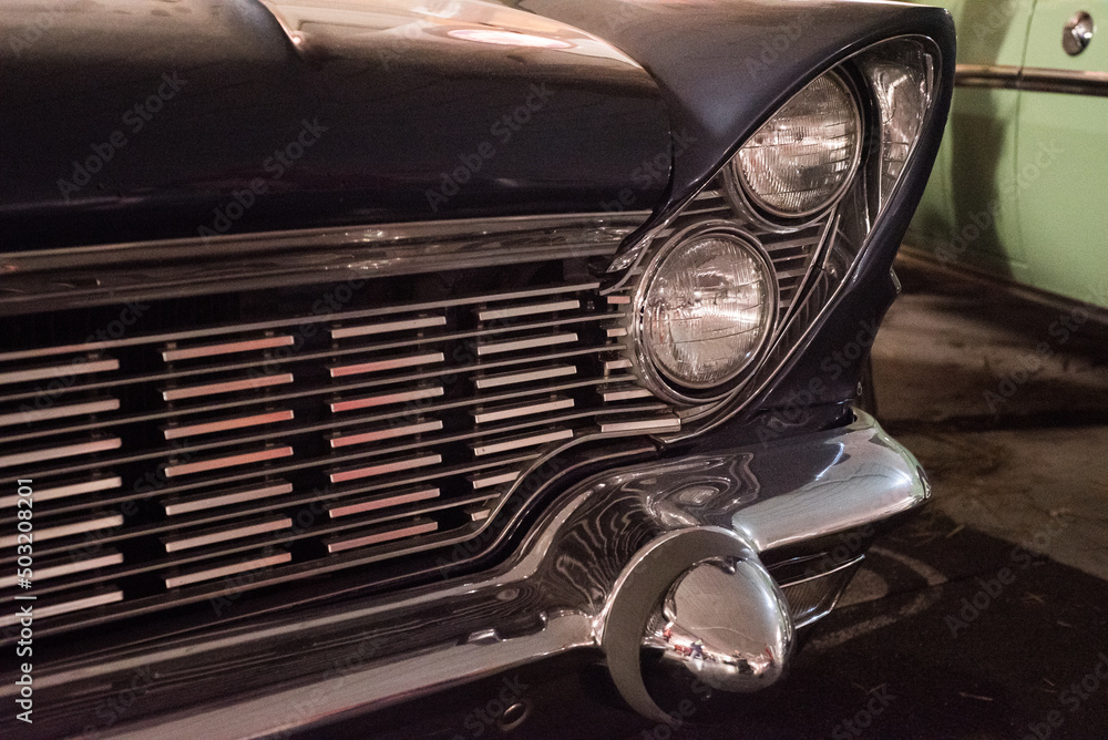 Fototapeta premium A headlight and a shiny car bumper