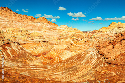 A hiker in the geological formation in northern Arizona known as the Wave