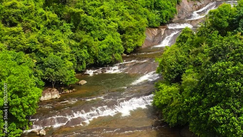 Beautiful waterfall in green forest. Tropical Kirindi Falls in mountain jungle, Sri Lanka. photo